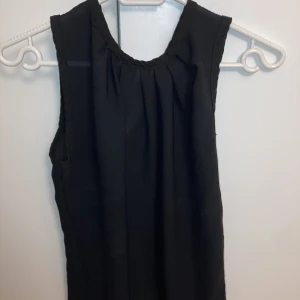 Lös svart sommar tröja - Lös svart somrig tröja, sittpt i halsen och flowsr ner