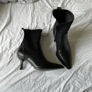 Svarta klackskor  - Ett par svarta klackskor från ginatricot. Storlek 36 och aldrig använda. Lite spetsigare modell med läder nere på skorna och annat material högre upp för skönare passform.🥰