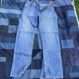 Vintage jeans - Helt sjukt detaljrika jeans, vintage och stift (hårda) har inte varit använda på flera år och därför är dom väldigt hårda men efter några användningar blir dom mjuka. Midjemått rakt över 42 cm, total längd 117 cm, benöppning 22 cm. Tveka ej på höra av dig