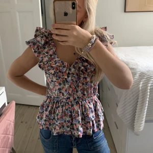 As fin blommig blus - Säljer denna as as fina blommiga blusen från hm med super fina volanger!! Perfekt till en mysig middag eller fest💕💕💕