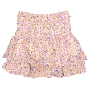 Mönstrad Kortkjol  - Varan kan köpas direkt på vår hemsida, ettmarke.se Färg: Vit, lila, röd, brun & rosa. Modell: Långkjol. Storlek: XS enligt lapp. Kan passa större och mindre storlekar pga resårbandet runt halva midjan. Midja platt rakt över: 33 cm. Totallängd midja: 45cm