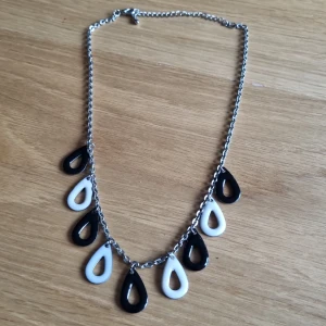 Svart vitt halsband - Halsband med svarta och vita hängen  Silverfärgad kedja, kortare modell