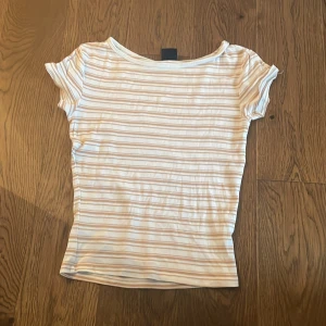 Beige och vit t-shirt från Gina tricot - Jag säljer en beige och vit tröjs från Gina tricot
