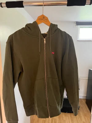 Levis zip hoodie - Grön Levis zip hoodie som har använts nu under vintern och hösten men som nu har blivit för liten för mig (cond 9/10)! Nypris 479kr!