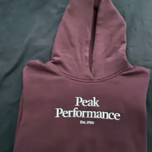 En helt ny brun Peak Performance hoodie i nyskick. Endast använd 1 gång.