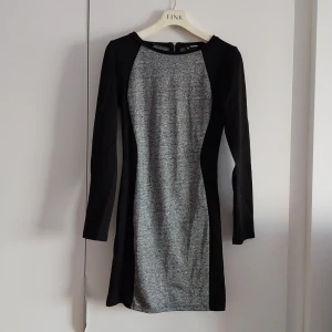 Långärmad kort klänning - Klänning frpn Hm. Använd 3 ggr max. Svart och grå. Storlek 38.  Betalning sker via swish och köparen står för frakten. 