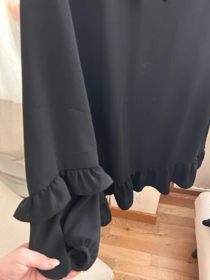 Klänning från zara  - Svart klänning från zara med volang 