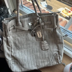 Handväska  - En medelstor väska som är beige/vit. Fett cool och snygg. Den är min mammas gamla men typ aldrig använd, vintage. Skriv för flera bilder.