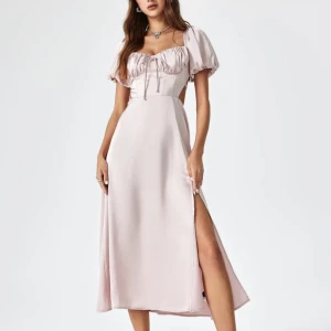 Otroligt fin rosa satinklänning - Superfin rosa satinklänning med puffärm, knytning i ryggen och slits. Endast provad. Storlek M. 