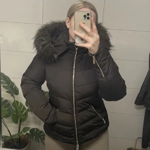 Brun vinterjacka - Säljer min bruna vinterjacka med guldiga dragkedjor.  Otroligt skön & varm.  Man kan absolut ha en tjocktröja under jackan.  Jackan är i gott skick.  Ett måste för den kommande vintern!❄️