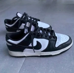 Nike dunk low retro - Tja! Säljer nu mina Nike dunk low panda! Storlek: 41. Skick: 8/10, skorna är i väldigt fint skick, bortsett från snörerna och hälen som har lite slitningar(se bild 3). Nypris: 1400kr. Mitt pris: 750kr. Hör av dig för fler bilder och info!