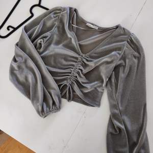 Thin stretchy shimmery top with puffy sleeves, great for a night out. Size M