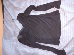 Topp - Jättesnygg topp! Likadan fram och bak. Spetsdetaljer vid kragen. Säljer pga att den inte kommer till användning.