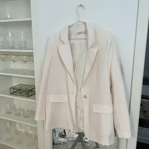 Helt ny vit blazer från NA-KD, har en lätt ton av beige/rosa. Storlek 34 men passar 34-38. 