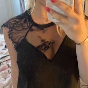 Fest topp - Super snygg topp med spets, köpt från secondhand. Super snygg till fest eller utekvällar.( glömt att knäppa knappen, ej sönder) 