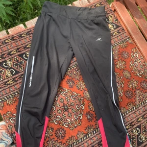 Tränings byxor  - Svarta tights med rosa detaljer vid vaderna, ficka finns på baksidan