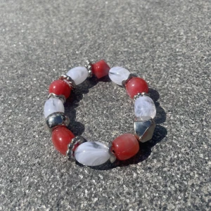Armband - Röd/vit armband gjort av större pärlor. Endast använd en gång, så i fint skick