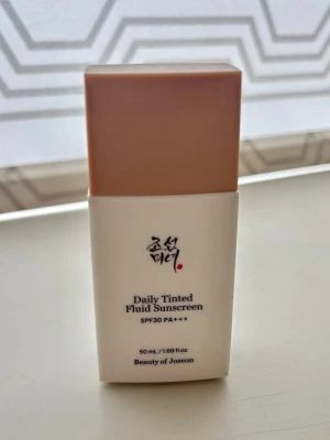 Beauty of Joseon Daily Tinted Fluid Sunscreen SPF30 nyans LP100 - Beauty of Joseon Daily Tinted Fluid Sunscreen SPF30 i ljusaste nyansen LP100.  Lätt färgad tint med SPF30 som skyddar huden och jämnar ut hudtonen. Mineraliskt solskydd. Endast testad, har använt uppskattningsvis max 5 ml. Ny flaska väger 84 gram, denna väger 79. 
