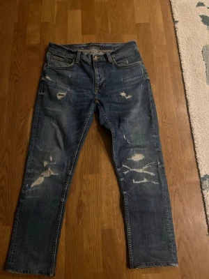 Nudie med slitningar - Ett par nudie lean dean med ruggigt sköna slitningar/lagningar, är i strl 31x32 men omsydda till 31x30. Sitter mer som 30x30, bara o höra av dig vid frågor😁 svarar och skickar snabbt👍🏻