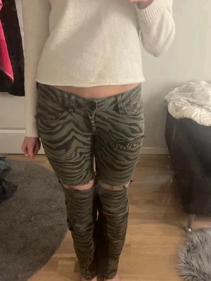 zebramönstrade jeans - Snygga zebramönstrade byxor i grönt och svart som jag har sytt ut till bootcut. Jag har gjort hålen själv🩷