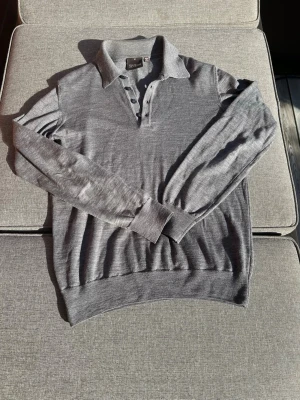 Oscar jacobson tröja - En fin tröja från Oscar jacobson gjord i Italien. Modellen kallas för Ruben poloshirt L-S. Det står storlek m på tröjan men skulle säga att den är som en S i storlek- kan ha krymt i tvätten. Hör gärna av er om ni vill ha mått eller om ni har några frågor!