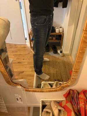 Blå raka jeans - Säljer ett par klassiska blå jeans med normal midja och raka ben. Jeansen har fem fickor, tydliga sömmar och en lätt tvättad look. Passar perfekt till en avslappnad stil och är gjorda i denimtyg.