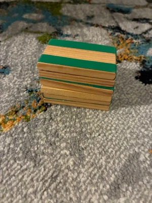 magiska brickor  - Ett set med rektangulära träklossar som har gröna och röda färgdetaljer. Denna klassiska träleksak kallas ofta för en "Jakobs stege" (Jacob's Ladder) eller "magiska brickor".. 