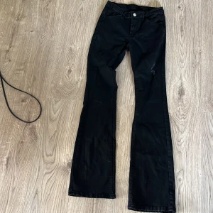 Svarta bootcut jeans - Köpta här på Plick men blev inte nöjd då de inte stämde överens med beskrivningen. Aja nu ska jag berätta!                                               Svarta bootcut Jeans men en liten tillgjord slitning på låret. Knappen är lite lös men tror den ska vara så!     Kontakta mig om du undrar något mer!🙏🖤🖤🖤