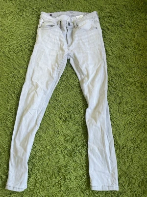 Ljusblå skinny jeans med fem fickor - Säljer ett par ljusblå skinny jeans i klassisk femficksmodell. Jeansen har smal passform, normal midja och är tillverkade i ett mjukt denimtyg med lite stretch. Perfekta för en avslappnad och trendig look.