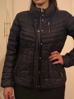 Jacka - Pufferjacka, perfekt till hösten. Gulddetaljer och polokrage.