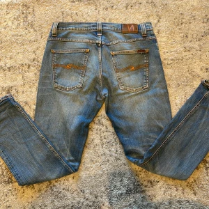 Blå jeans från Nudie Jeans - Nudies i fint skick i modellen grim Tim storleken är 34/32