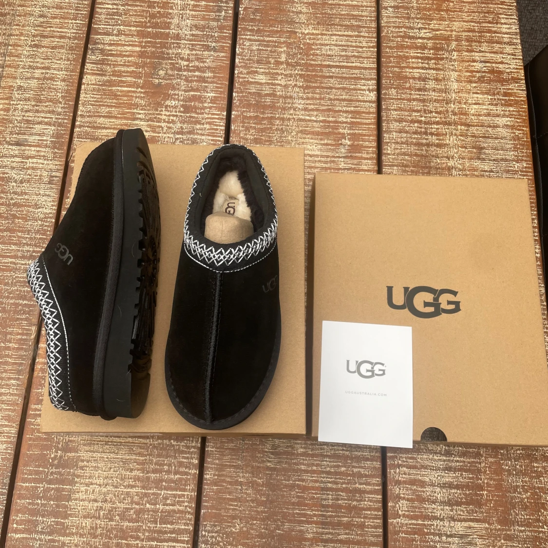 Svarta UGG slip-ons med mönstrad kant