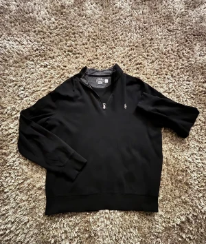 Svart half zip tröja från Polo Ralph Lauren - Svart långärmad tröja från Polo Ralph Lauren med half zip och klassisk broderad logga på bröstet. Storlek M.Tröjan har en normal passform och är tillverkad i mjuk bomull med inslag av polyester, perfekt för chill höst- och vinterdagar. Jag har bara använt den ett fåtal gånger då den är för stor för mig så den är i ett otroligt bra skick👌. Har du någon fundering så är det bara att skriva👍