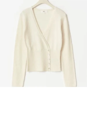 Vit kofta med knappar  - Snygg vit omlottkofta från Other Stories med v-ringning och dekorativa knappar längs sidan. Koftan är långärmad, har en croppad passform och är stickad i mjukt material som känns lyxigt. Perfekt att styla med jeans för en chill look. Slutsåld online