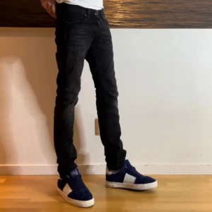 Jack n jones jeans - Säljer ett par svartgrå jeans från Jack and Jones  med klassisk femficksdesign och slim passform. Jeansen har en mörk tvätt och är tillverkade i stretchigt jeansmaterial som sitter perfekt längs benen. Perfekta för en clean och stilren look. Storlek 27/30