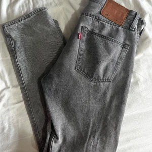 Levi’s 501 Grå - Gråa 501 ifrån Levi’s. I använt skick med en liten defekt som syns på sista bilden. Defekten går att lösa med nål och lite tråd.   Storlek: W30 L32  Hör gärna av dig för fler bilder eller mer information. 