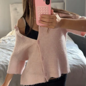 Ljusrosa stickad kofta med knappar - Superfin ljusrosa stickad kofta med trekvartsärm och knappar framtill. Koftan har en loose passform och är perfekt att slänga över ett linne. Mjuk och mysig känsla. Strl 158/164 men sitter som XS/S💞