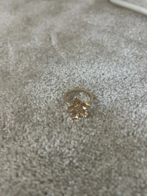 Guldfärgad ring med blomma - En fin gullig ring men en blomma, ringen är i storlek ungefär S-M💞 
