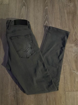Replay svarta slim jeans - Snygga svarta jeans från Replay med klassisk femficksdesign och diskret Replay-logga på bakfickan. Modellen har smal passform och raka ben, tillverkade i stretchigt jeanstyg för extra komfort. Perfekt för dig som gillar stilrena och moderna jeans.