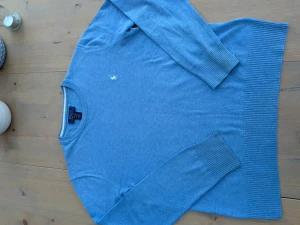 Blå tröja från Polo Ralph Lauren - Snygg blå tröja från Polo Ralph Lauren i mjuk pima bomull. Klassisk rund hals och ribbade muddar vid ärmslut och nederkant. Diskret broderad logga på bröstet. Perfekt för dig som gillar stilrena och tidlösa plagg.