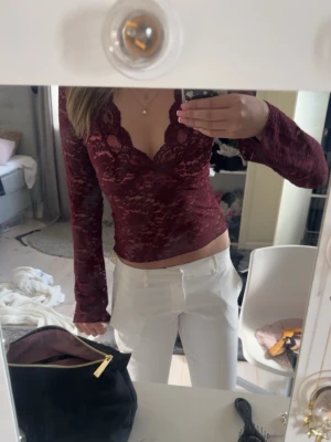 Vinröd spetsblus med v-ringning - Säljer en vinröd långärmad blus i spets med v-ringad hals och figurnära passform. Köpt på gina tricot nyligen