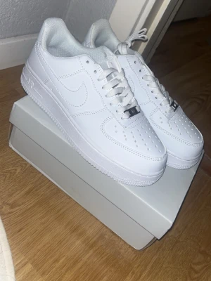 Nike Air Force 1 vita sneakers - Fräscha (helt nya) och stilrena Nike Air Force 1 sneakers i helvitt med klassisk design. Perfekta för dig som vill ha en clean look och gillar streetstyle.