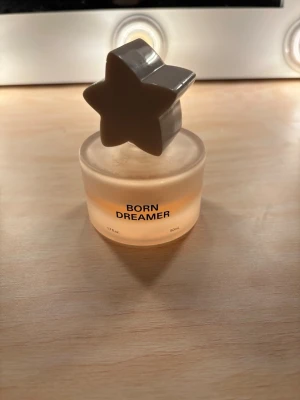 Born Dreamer parfym 50ml - Born Dreamer parfym i en unik flaska med stjärnlock. Volym: 50 ml. Perfekt för dig som vill sticka ut med en cool och trendig accessoar på sminkbordet. Fruktig och blommig doft!