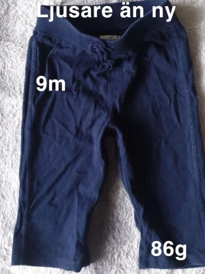 Mörkblå mjukisbyxor med snörning - Mörkblå mjukisbyxor för baby med bekväm resårmidja och snörning framtill. Byxorna har en enkel, rak passform. Perfekta för chill dagar hemma eller lek på golvet.🌸Fint använt skick. Ljusare än nya. Storlek 9 månade (80) 
