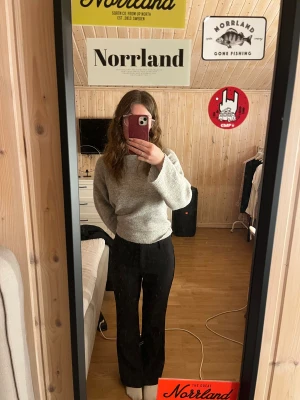 Svarta kostymbyxor med bootcut - Säljer ett par svarta kostymbyxor med bootcut-snitt. Byxorna har en klassisk rak passform och är tillverkade i ett mjukt tyg som ger en snygg siluett. Perfekta för dig som vill ha en stilren look med lite extra edge.