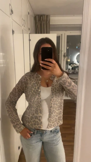 Beige leopardmönstrad kofta - Säljer en beige och grå kofta med leopardmönster.