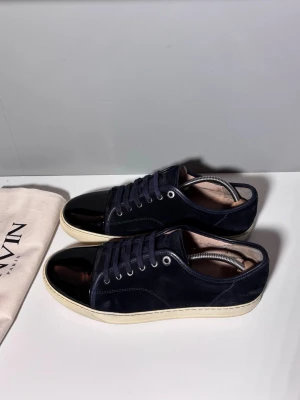 Lanvins  - Säljer ett par snygga lanvins i mörkblå färg, storlek UK10 (EU44), cond 7,5/10 heeldrag, mockan i okej skick och lite slitet på insidan men annars gott skick! Kommer med dustbag!