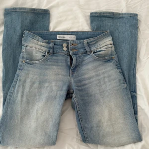 Lågmidjade bootcut jeans - Säljer mina älskade jeans från bershka då jag inte använder de längre. De är i fint skick och passar perfekt på mig som är 168cm. Jag har satt två extra knappar så de ska sitta bättre i midjan som man enkelt kan ta bort eller flytta om man vill.