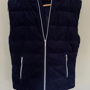 Mörkblå manchester dunväst med huva - Säljer min vendiera väst. 10/10 skick.