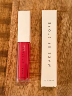 Make Up Store Lip Plumper Berry Läppglans Ny Oöppnad - Säljer ett Lip Plumper läppglans från Make Up Store i en snygg rosa nyans. Kommer i en stilren fyrkantig tub med vit kork och transparent hylsa som visar färgen. Perfekt för dig som vill ha fylligare och glansiga läppar med en fräsch look. Ny, oanvänd och oöppnad. Nypris 179 kr.